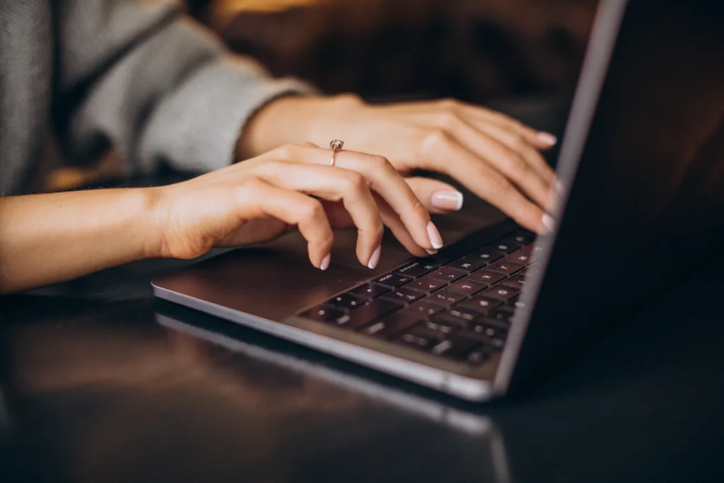 Employee typing on a laptop ahead of Windows Server 2016 end of support